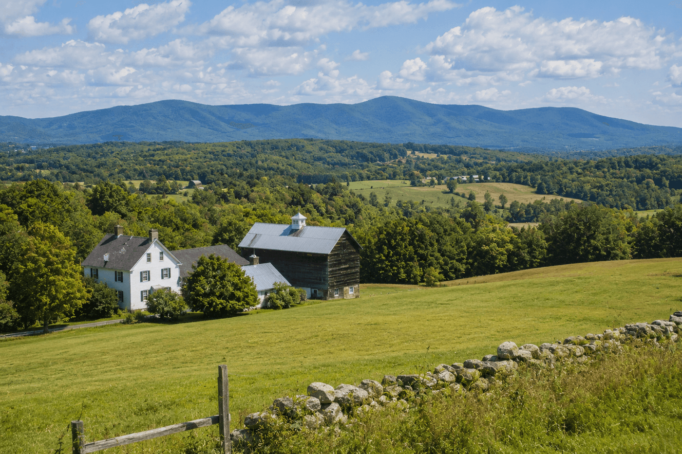 The rolling hills and woodland of Sharon, Connecticut in Litchfield County, with the Taconic Mountains visible and the pastoral character of Connecticut's northwest corner.