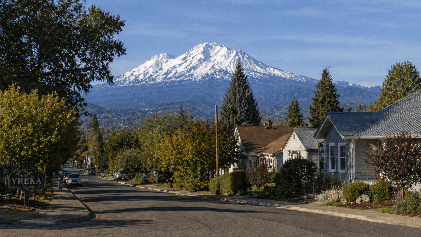 A quiet residential street in Yreka, California, a small town in Siskiyou County near the Oregon border, with modest homes and Mount Shasta visible in the distance.