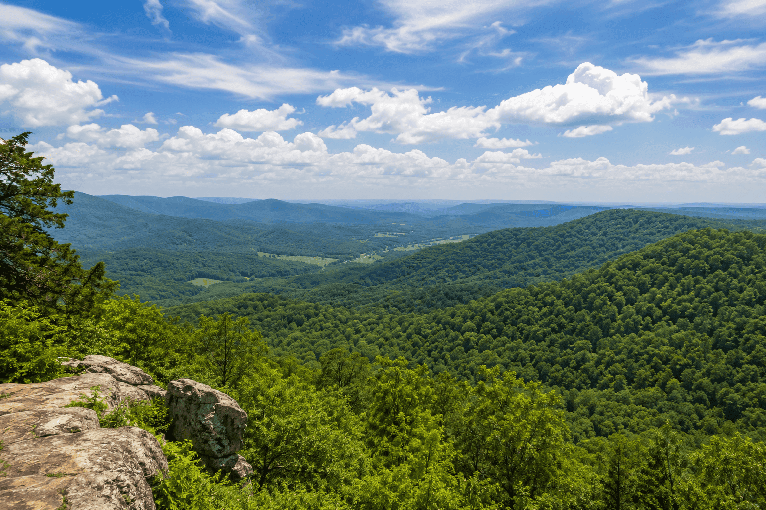 The Ozark Mountains near Chester, Arkansas, with forested ridgelines and the rolling hills of Crawford County under a wide sky.