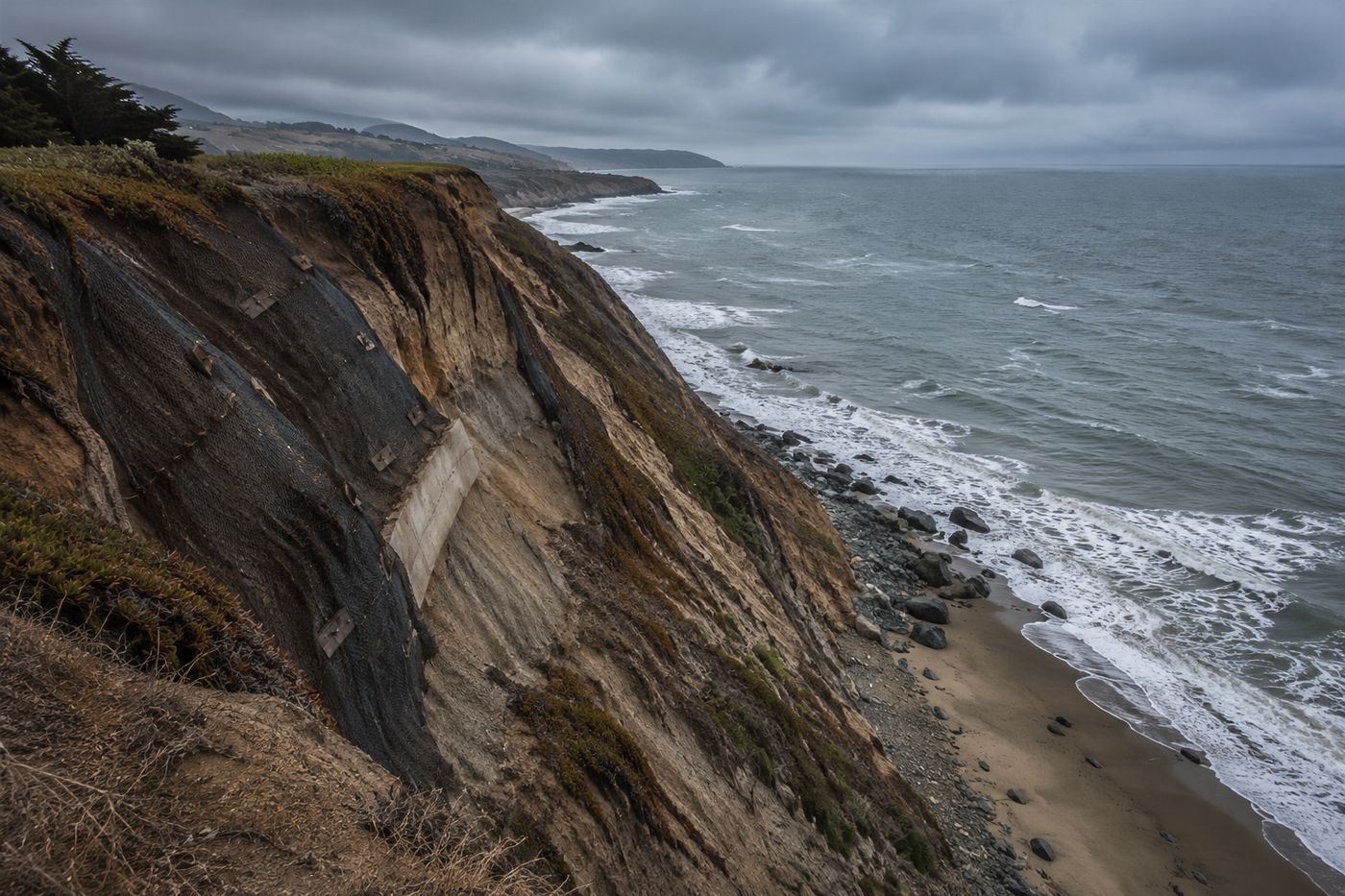 Dramatic Pacific Ocean cliffs in Pacifica, California with erosion-exposed bluffs and waves crashing below
